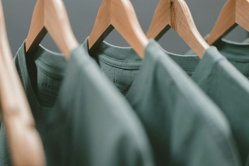 Neutral knitwear and wardrobe basics arranged on a rail